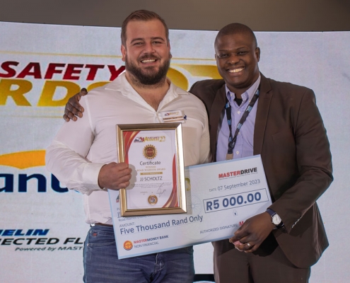 Jonathan-Mphake-hands-award-to-Road-Warrior-finalist-JJ-Scholtz-MCV